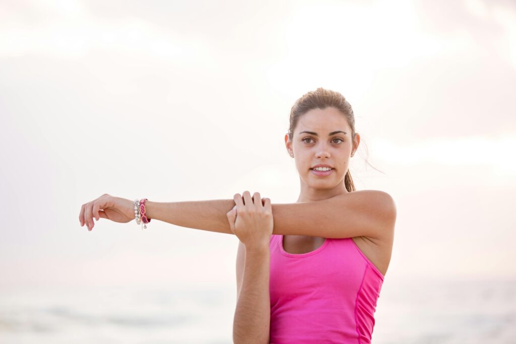 Woman stretching outdoors to keep knee joints active and healthy